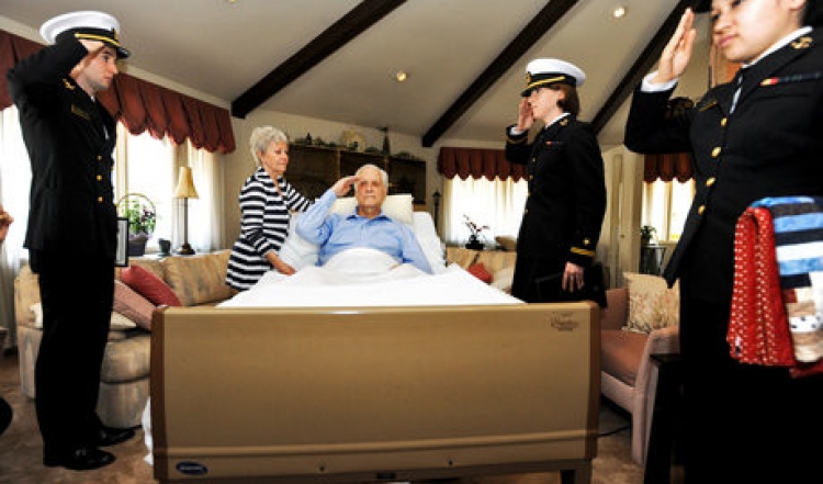 USNA Midshipmen volunteer to administer “Honor Salute” to dying Veterans.  Richard is the dying Vet, wife and several family members