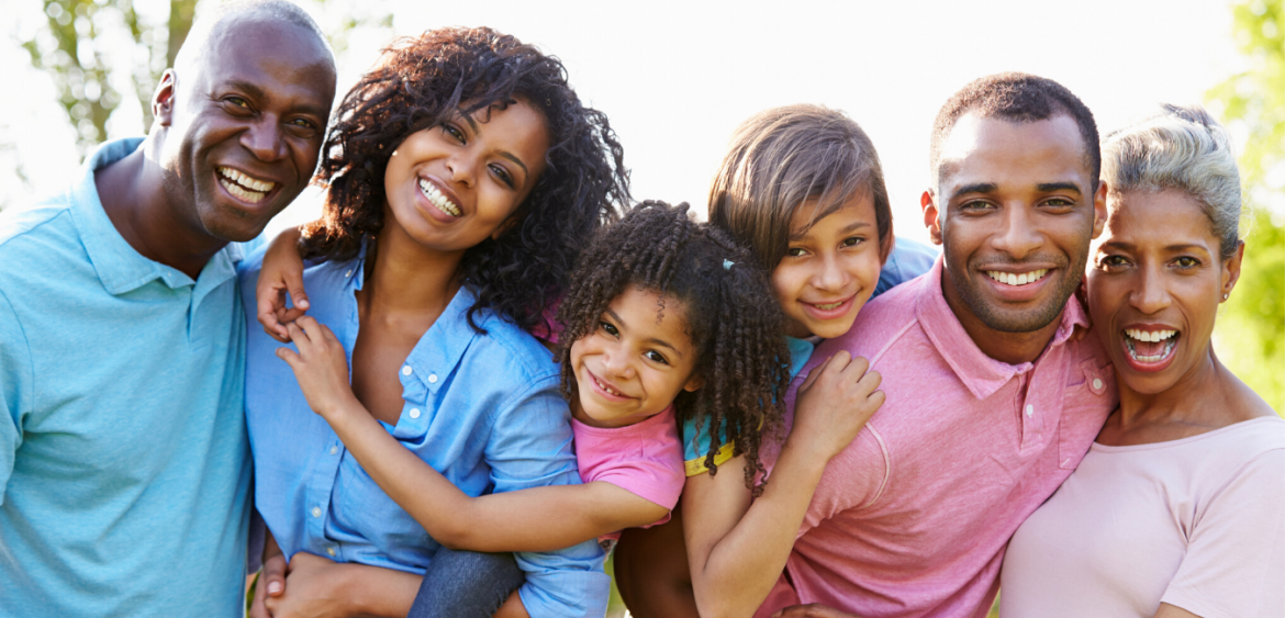 African American family including grandparents, parents and children smiling and together