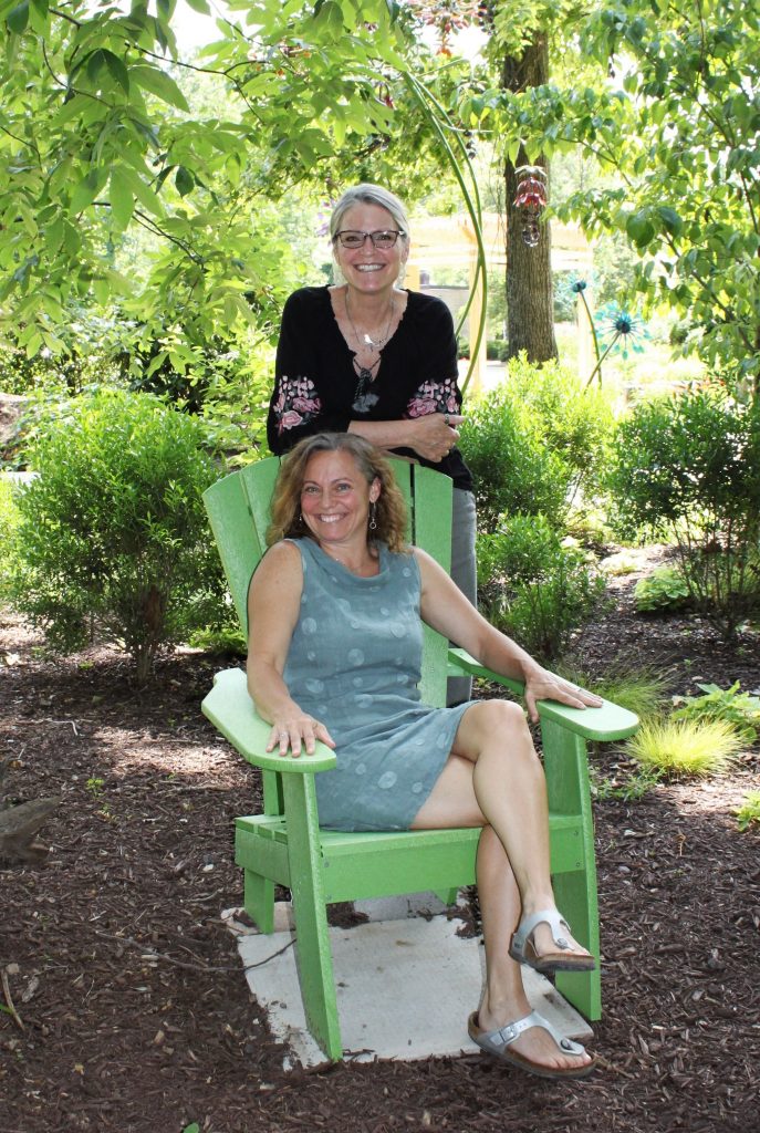 Hospice of the Chesapeake Integrative Arts Volunteers Jill Madey, left, and Teri Jacobson, are pictured in a shady spot in the Children's Memorial Garden. 