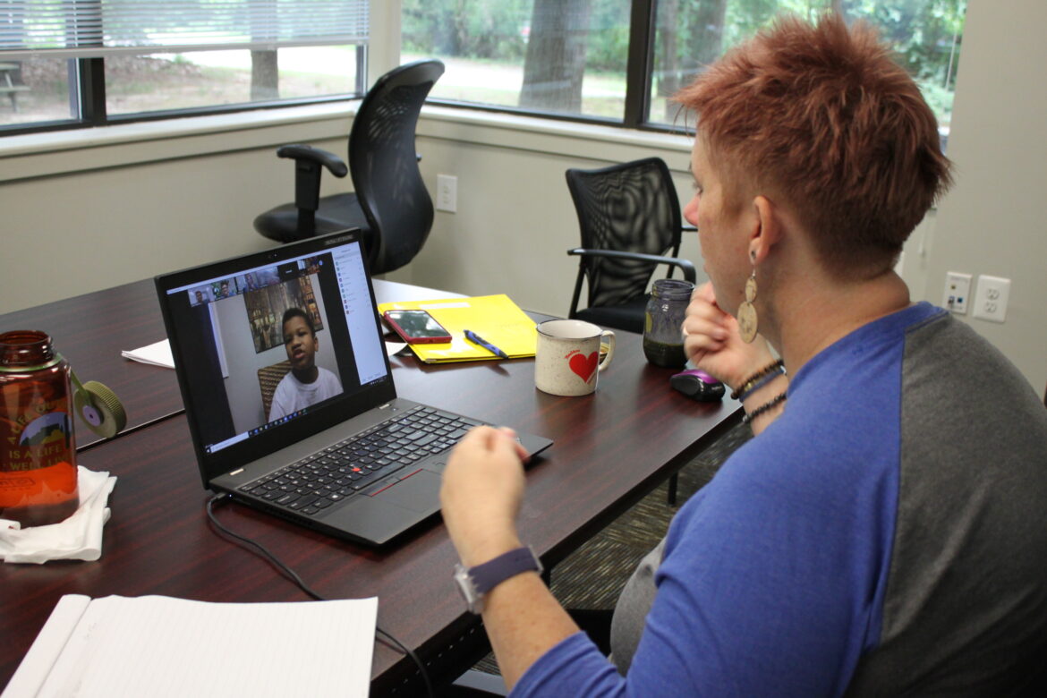 Chesapeake Life Center Bereavement Services Manager Amy Stapleton plays a game of charades with camper Jyair Levenberry during the second day of Grief Burst 2020!, a virtual grief camp held in August.
