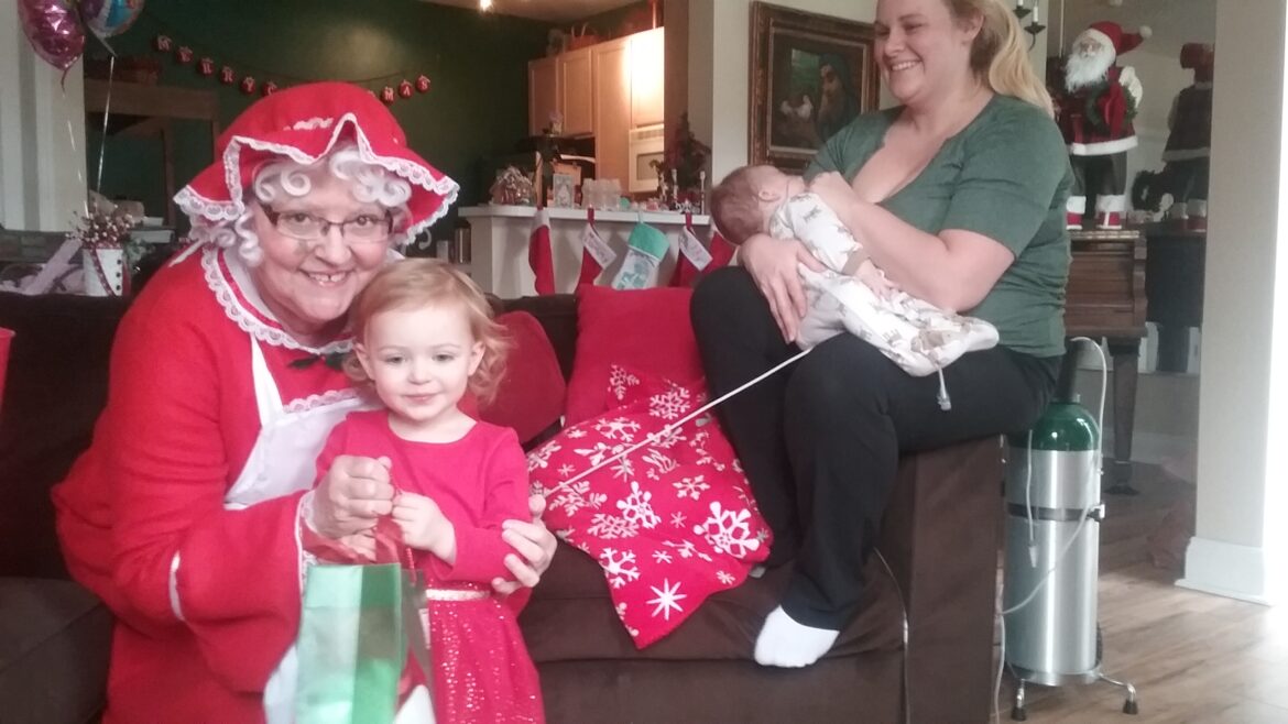 Hospice of the Chesapeake Volunteer Alice Jo Weaver dressed as Mrs. Santa to deliver gifts to a pediatric hospice family