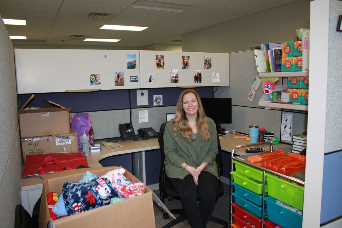 Hospice of the Chesapeake Child Life Specialist Alex Haarich in her cubicle surrounded by tools and resources she needs to help pediatric hospice families