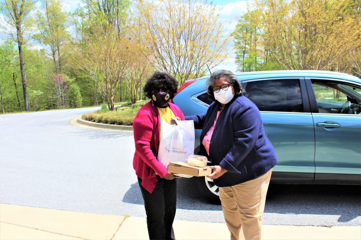 From left, Delegate Edith Patterson, Hospice of the Chesapeake Board member, receives her wine and charcuterie kit from Hospice of Charles County Donor Relations Manager Gwen Russell at the organization’s offices in Waldorf. 