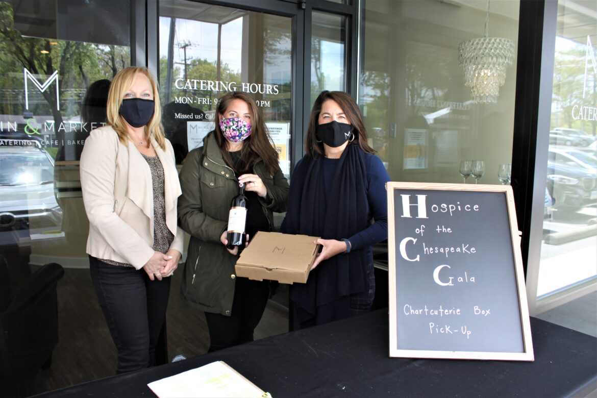 From left, Hospice of the Chesapeake’s Director of Advancement and Volunteer Services Chris Wilson and Event Coordinator Meg Lawton stand with Main & Market’s Vice President Evie Turner in Annapolis ready to give the Italian wine and charcuterie to participants of the virtual Tuscan Twilight Tasting fundraiser.