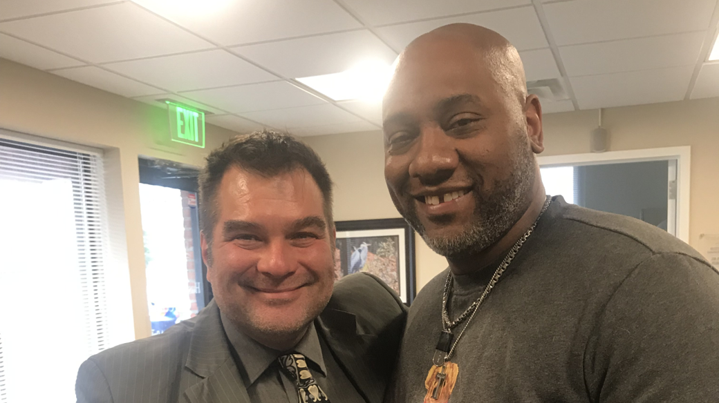 Eric Bush, MD, poses with his patient of 8 years, Brian Thompson, in the Hussman Supportive Care Center on the John & Cathy Belcher Campus in Pasadena, Maryland.