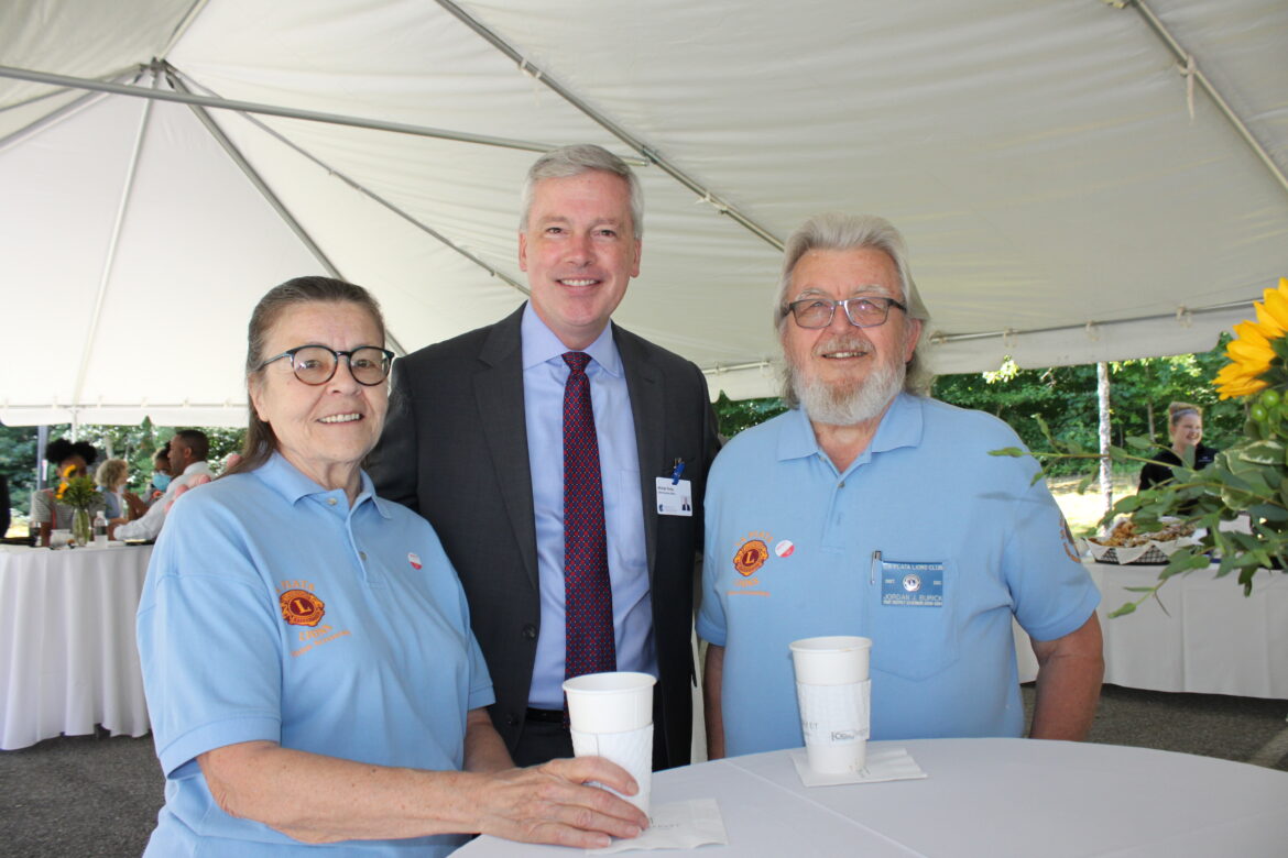 Connie and Jordan Burick of the LaPlata Lions Club flank Hospice of the Chesapeake President and CEO Mike Brady at the Hospice of Charles County Ribbon Cutting on June 23, 2021.