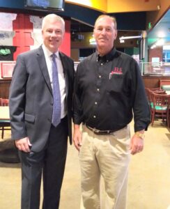 (Oct. 13, 2021) Rotary Club of Charles County (La Plata) President Chris Zabriskie, right, greets Hospice of the Chesapeake CEO Mike Brady at the club’s weekly breakfast meeting at the Greene Turtle in La Plata, Maryland. Courtesy photo