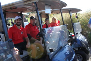 The team from Permits Plus, Inc., is ready to roll before the shotgun start of the Golf Tournament