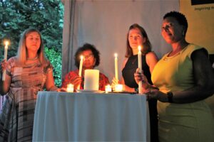 Candles glow to honor. The candles were lit by, from left, Dr. Gail Andrews, Chief of Mission for the Embassy of the Republic of South Africa; Nomaindiya Mfeketo, Ambassador of The Republic of South Africa; Monica Hastings, RN, Clinical Manager for Hospice of the Chesapeake; and Lumka Mgqolozana, RN, representing South Africa.