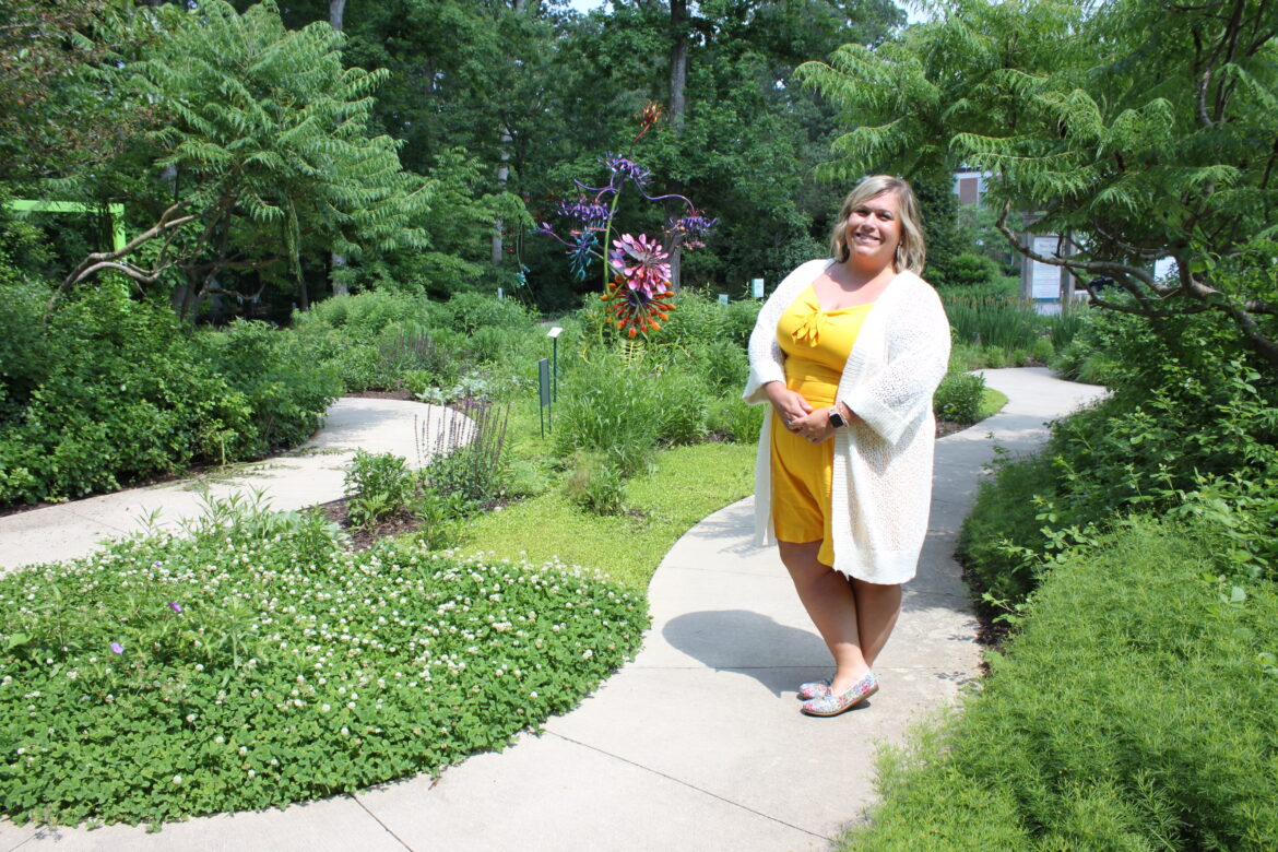 Alena Dailey, Integrative Arts Manager for the Volunteer Team, stands in the Michael Stanley Children's Garden