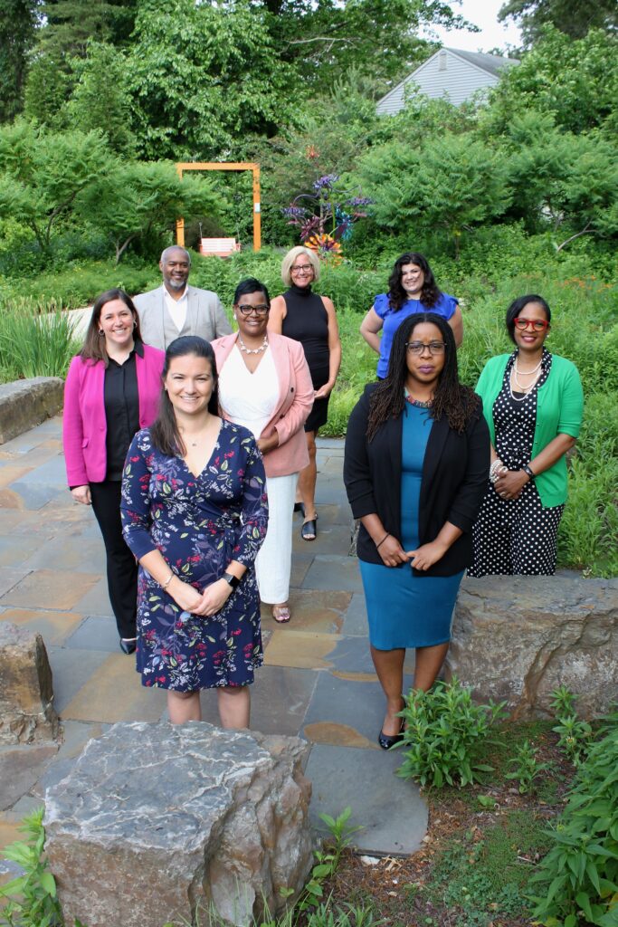 Dementia Advisory Group Poses in the Michael Stanley Children's Garden on the Hospice of the Chesapeake Campus