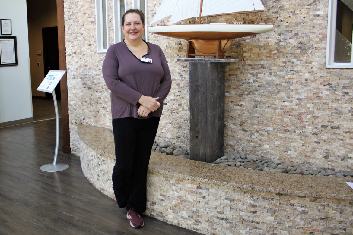 Melissa Livingston stands in the lobby of the Rebecca Fortney Inpatient Care Center before she begins her shift as a Compassionate Touch volunteer.