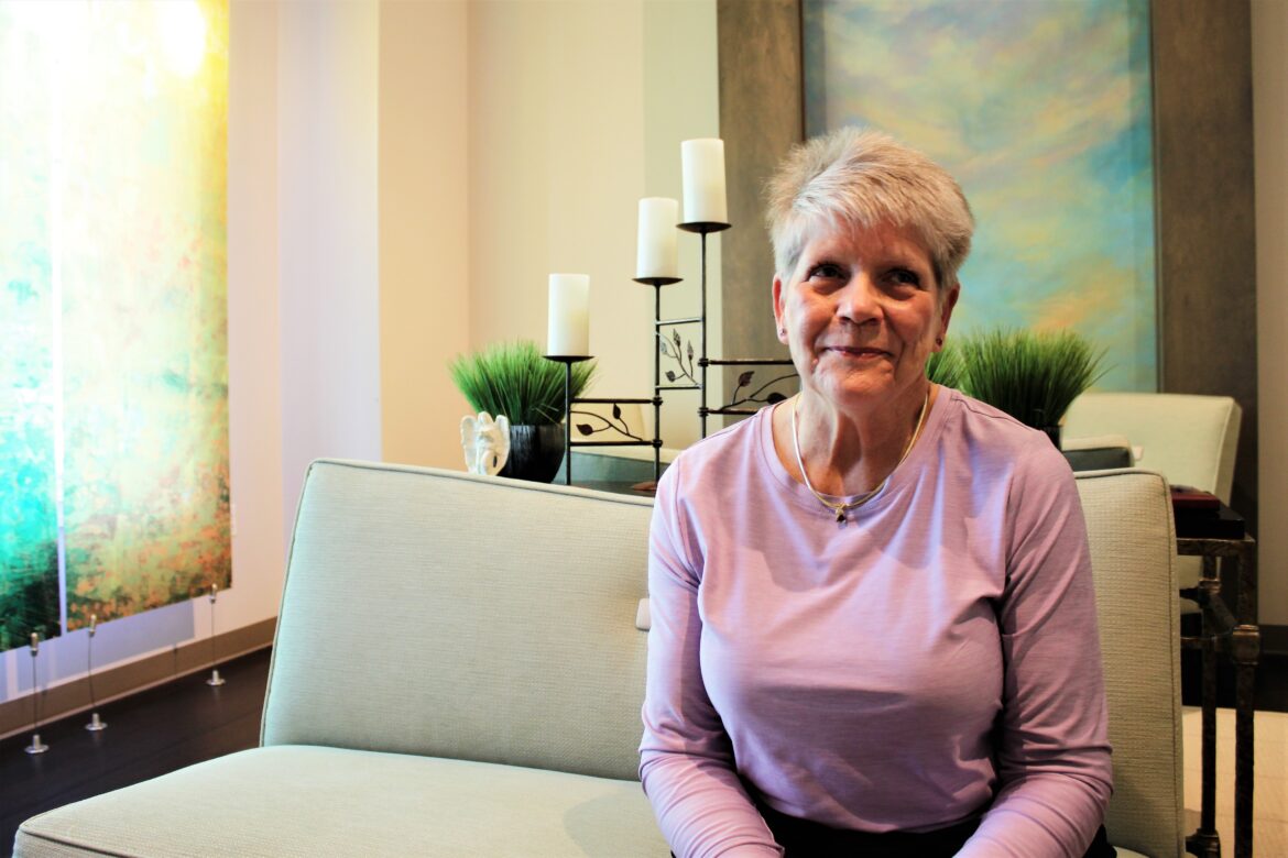 Sharon Downey sits in the Sanctuary in the Rebecca Fortney Inpatient Care Center before beginning her shift as a Compassionate Touch volunteer.