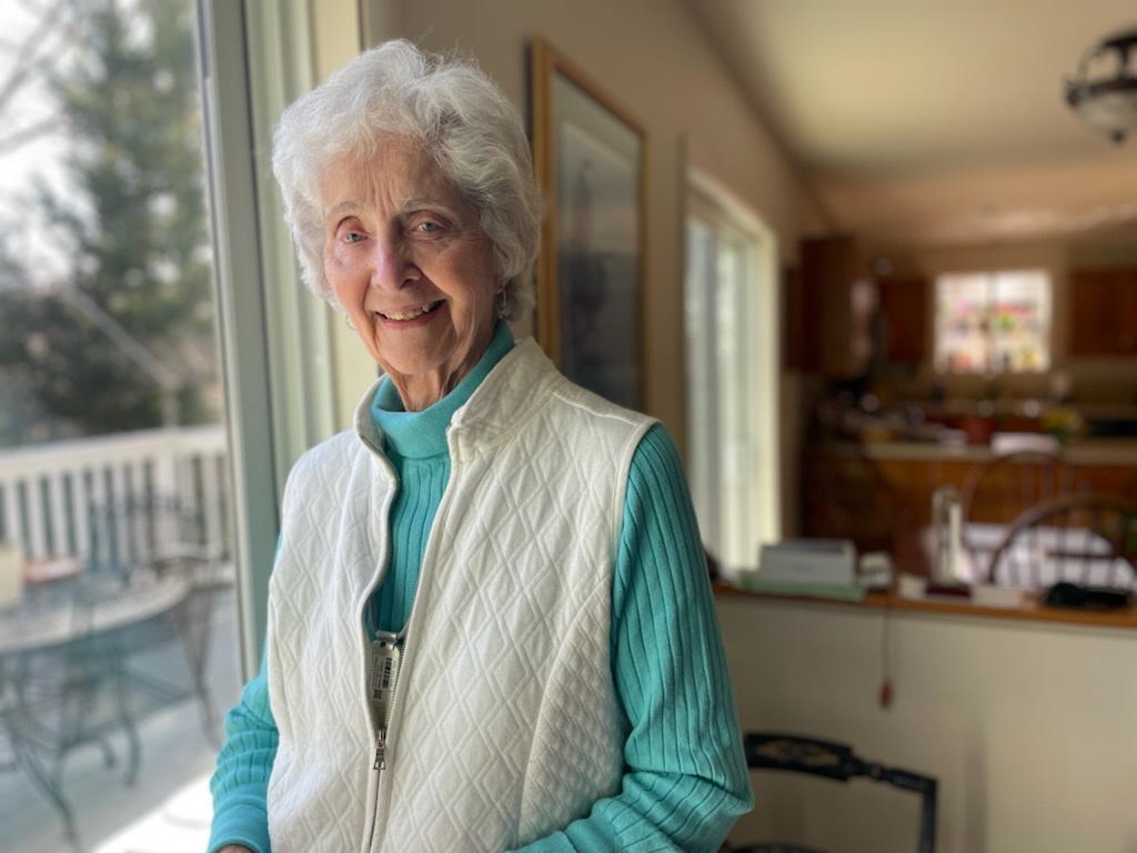 Mary Kathryn Alter, Ph.D., stands by the window of her Edgewater home. She enjoys giving to Hospice of the Chesapeake through a QCD