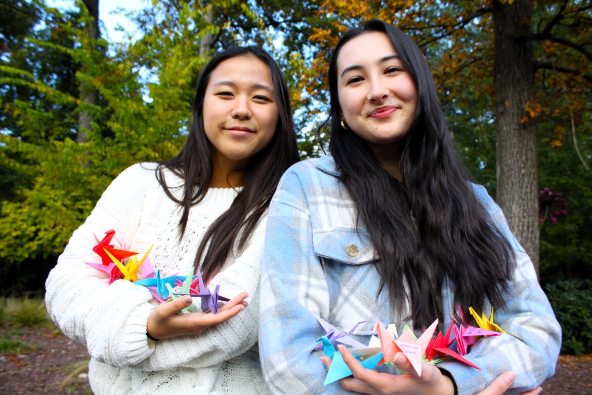 Severna Park High School juniors Hannah Kim, left, and Kateri Jarvis, are the founders of their  chapter of the Wishing Crane Project. Members craft origami cranes, adding messages of hope on their wings to give to hospice patients.