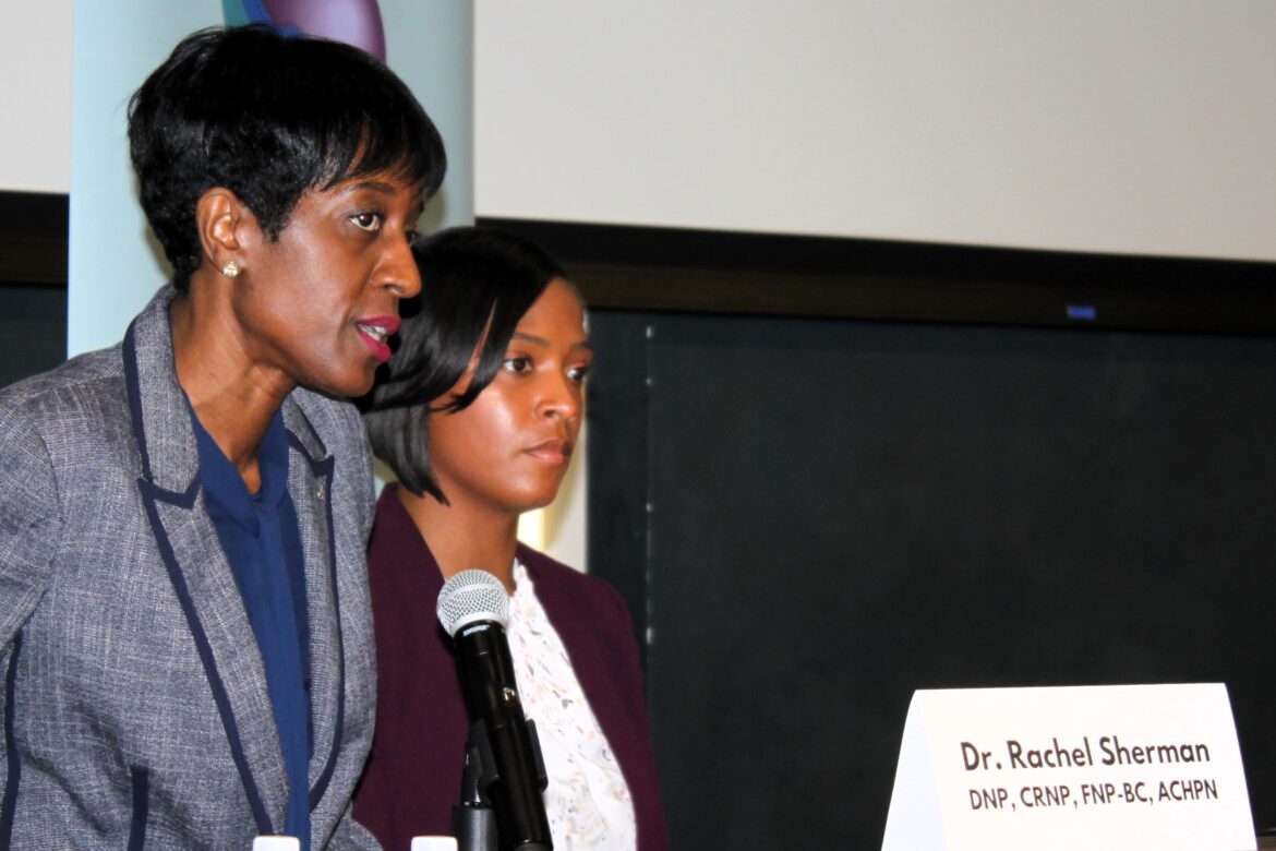 Rachel Sherman’s mentor, nursing consultant Dr. Melani Bell, DN, RN, shares a moment at the podium with the audience and panel. Medical professionals and elected officials gathered at Bowie State University to discuss "Hospice and Palliative Care in Prince George’s County.