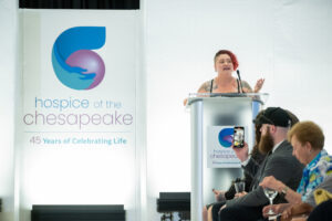 Fashion for a Cause: Marie Burgess shares her family’s journey with the Chesapeake Kids program. As she talked about the brief life of her son Harvey, who was a pediatric hospice patient, the room fell silent. Photo by Mike B. Photography